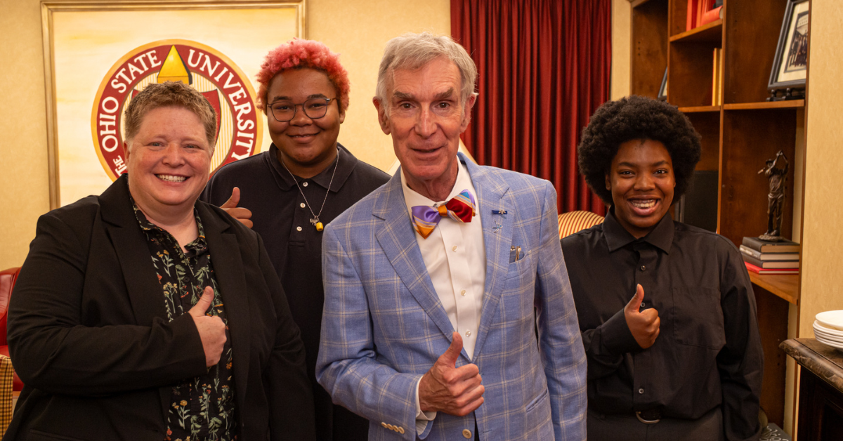 Bill Nye with students and thumbs up